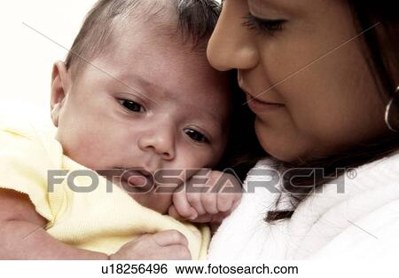 Hispanic mother holding infant View Large Photo Image Stock Photograph - Hispanic mother holding infant. Fotosearch