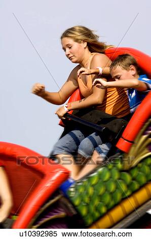 Stock Photography - Kids on a carnival ride. Fotosearch