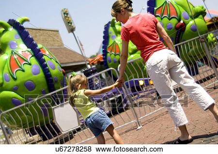 Stock Photo - Mother and daughter at carnival. Fotosearch