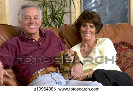 Stock Photography - Senior couple on couch. Fotosearch