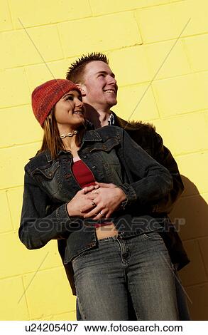 Teenagers leaning against a yellow wall Teenagers leaning agains View Large Photo Image Stock Photo - Teenagers leaning against a yellow wall Teenagers leaning agains. Fotosearch