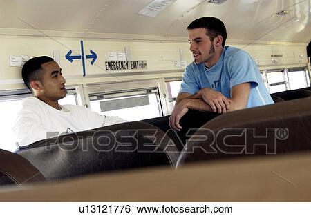 Two guys talking on bus View Large Photo Image Stock Photograph - Two guys talking on bus. Fotosearch