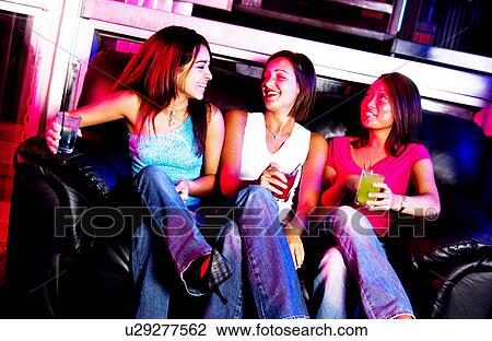 Young adults at a nightclub View Large Photo Image Stock Image - Young adults at a nightclub. Fotosearch