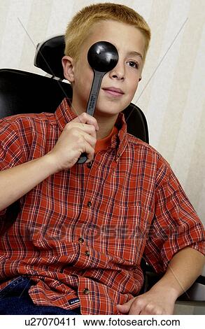 Stock Image - Boy getting eye exam. Fotosearch