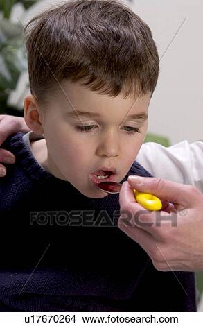 Picture - Boy taking medicine. Fotosearch