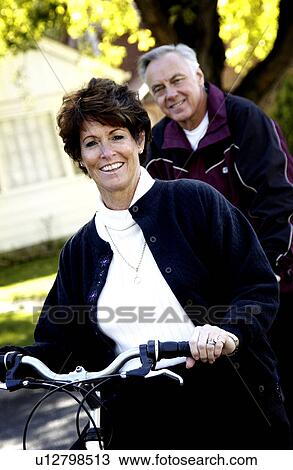 Couple riding bicycles View Large Photo Image Stock Image - Couple riding bicycles. Fotosearch