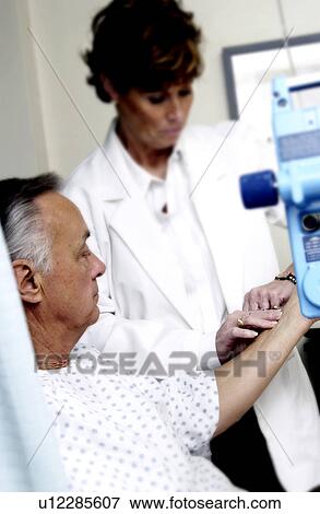 Doctor checking patients pulse View Large Photo Image Stock Photo - Doctor checking patients pulse. Fotosearch