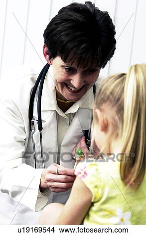 Doctor examining child Doctor examining child View Large Photo Image Picture - Doctor examining child Doctor examining child . Fotosearch