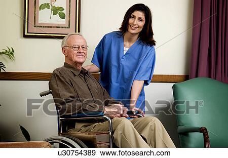 Stock Photo - Man in wheelchair with nurse. Fotosearch