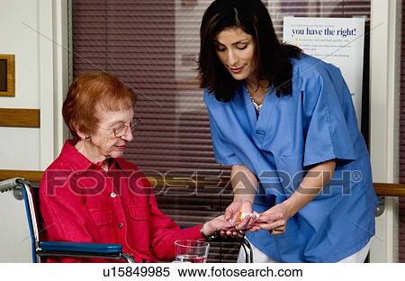 Nurse giving senior woman pills View Large Photo Image Stock Photography - Nurse giving senior woman pills. Fotosearch