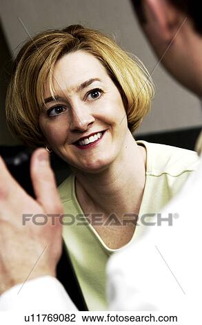Stock Image - Patient consulting with physician. Fotosearch
