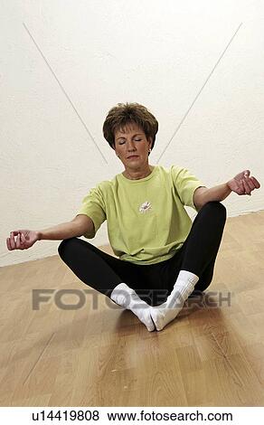 Stock Photo - Senior woman doing yoga. Fotosearch