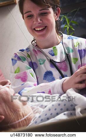 Senior woman holding hands with nurse View Large Photo Image Stock Image - Senior woman holding hands with nurse. Fotosearch