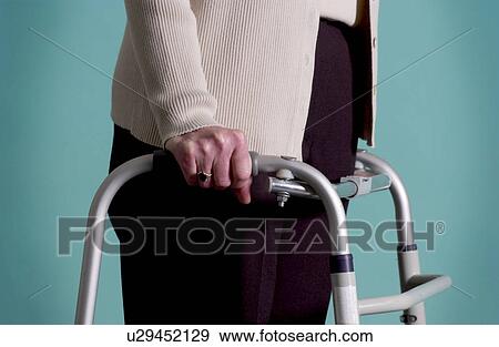Senior woman walking with walker View Large Photo Image Stock Photo - Senior woman walking with walker. Fotosearch