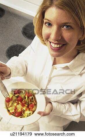 Woman eating salad View Large Photo Image Stock Photo - Woman eating salad. Fotosearch