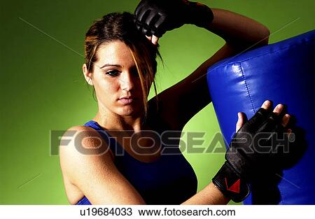 Stock Image - Woman practicing boxing. Fotosearch