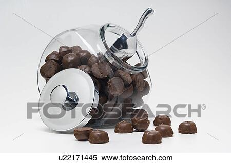 Chocolate candy in glass container with metal lid off View Large Photo Image Stock Photography - Chocolate candy in glass container with metal lid off. Fotosearch