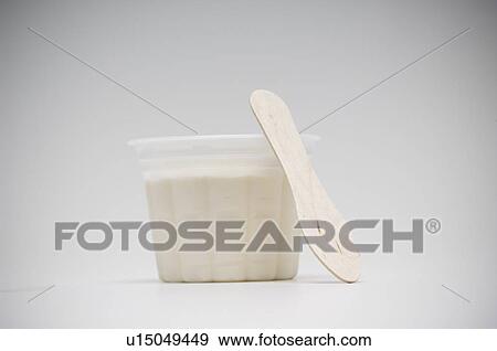 Stock Photo - Cup of vanilla ice cream with wooden spoon. Fotosearch