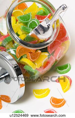 Stock Photo - Fruit flavored gummy candy in glass container with metal lid off. Fotosearch