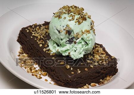 Fudge brownie with mint chocolate chip ice cream and nuts View Large Photo Image Stock Image - Fudge brownie with mint chocolate chip ice cream and nuts. Fotosearch