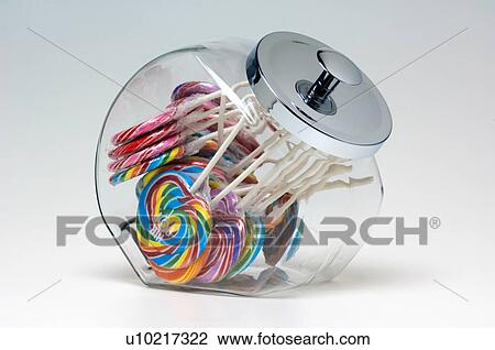Stock Image - Lollipops in glass container. Fotosearch