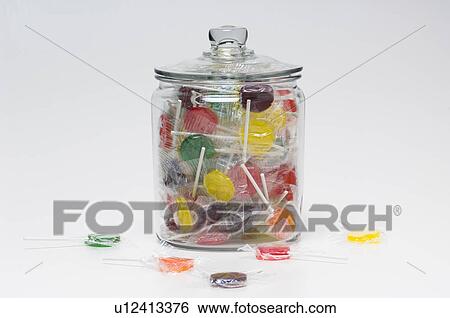 Lollipops in glass container with lid View Large Photo Image Stock Photograph - Lollipops in glass container with lid. Fotosearch