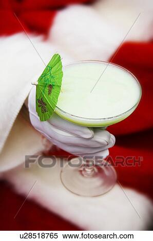 Stock Photography - Santa holding tropical drink. Fotosearch