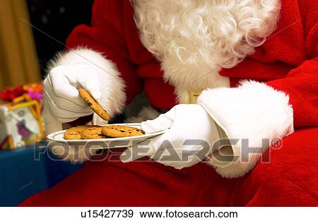 Stock Photo - Santa with plate of cookies. Fotosearch