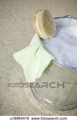 Cleaning cloth and brush in bucket of soapy water View Large Photo Image Stock Photograph - Cleaning cloth and brush in bucket of soapy water. Fotosearch