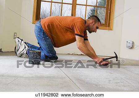 Construction worker laying subfloor View Large Photo Image Stock Image - Construction worker laying subfloor. Fotosearch