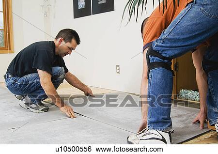 Construction workers laying subfloor View Large Photo Image Stock Photograph - Construction workers laying subfloor. Fotosearch