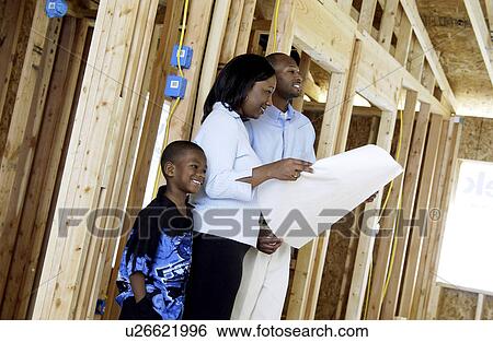 Family looking at their new home plans View Large Photo Image Stock Photograph - Family looking at their new home plans. Fotosearch