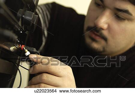 Man fixing stereo View Large Photo Image Picture - Man fixing stereo. Fotosearch