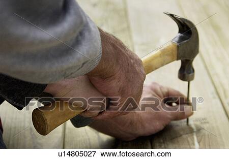 Stock Photo - Man hammering. Fotosearch