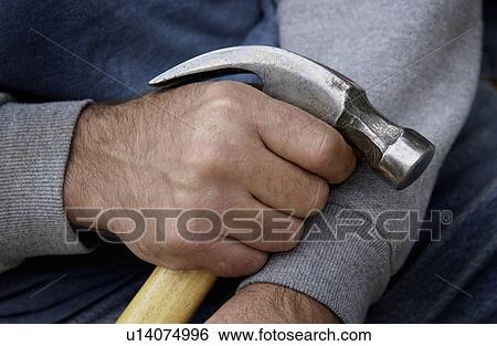 Stock Photograph - Man holding hammer. Fotosearch