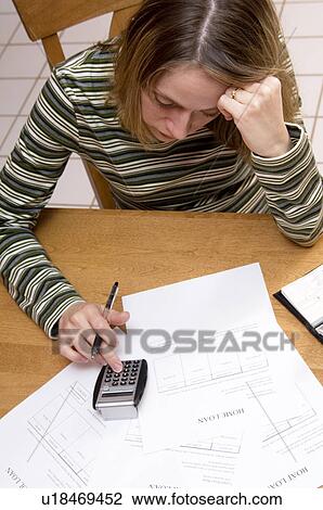 Stock Image - Woman paying bills. Fotosearch