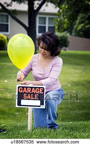 Woman putting up garage sale sign View Large Photo Image Stock Photography - Woman putting up garage sale sign. Fotosearch