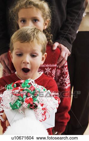 Picture - Boy getting a gift from Santa. Fotosearch