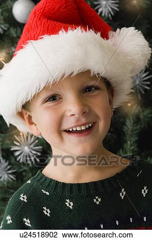 Boy wearing Santa hat View Large Photo Image Stock Image - Boy wearing Santa hat. Fotosearch