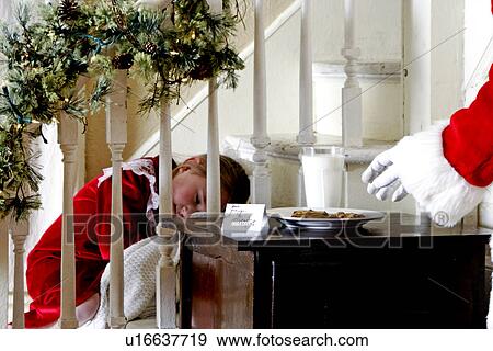 Child sleeping during Santas visit View Large Photo Image Stock Photo - Child sleeping during Santas visit. Fotosearch