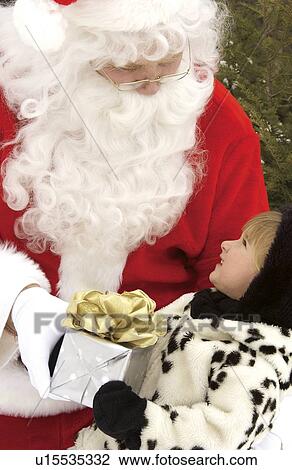 Girl getting gift from santa View Large Photo Image Stock Image - Girl getting gift from santa. Fotosearch