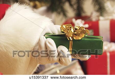 Santa handing out gifts View Large Photo Image Stock Photo - Santa handing out gifts. Fotosearch