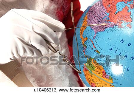 Stock Image - Santa holding globe. Fotosearch