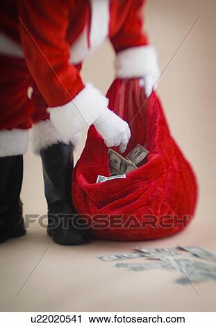 Santa putting money into bag View Large Photo Image Stock Image - Santa putting money into bag. Fotosearch