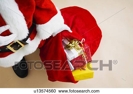 Stock Image - Santa with bag of gifts. Fotosearch