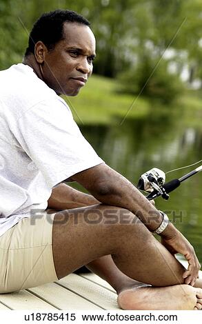 African American man fishing on dock View Large Photo Image Stock Photography - African American man fishing on dock. Fotosearch