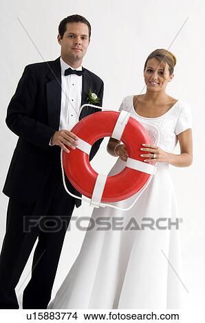Picture - Bridal couple holding life preserver ring. Fotosearch