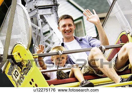 Stock Photograph - Father and son on ferris wheel. Fotosearch