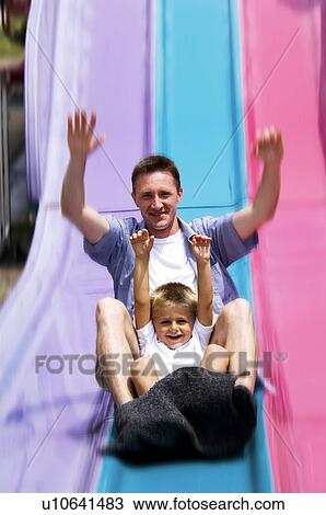 Father and son on slide View Large Photo Image Stock Image - Father and son on slide. Fotosearch