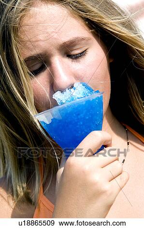 Girl eating carnival food View Large Photo Image Stock Photo - Girl eating carnival food. Fotosearch